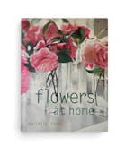 A book cover wth pink peony flowers in clear glass vases