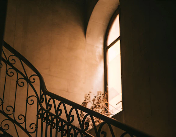 Moody Palermo street or interior scene in strong light and shadow, suggesting the city’s layered, turbulent history and quiet rebirth