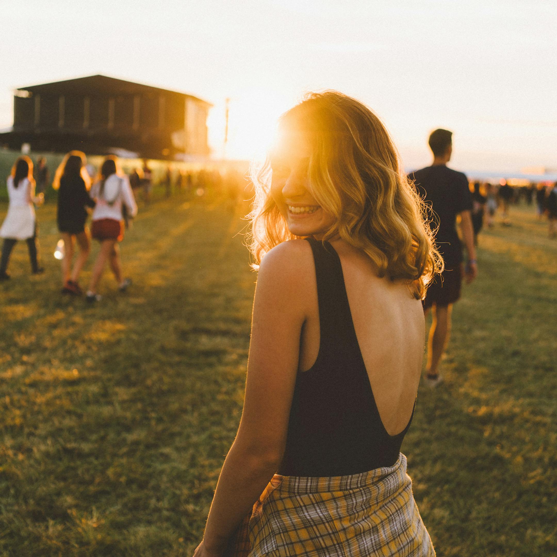 Jeune femme dans un champ converti en festival