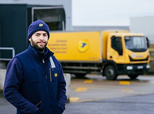 post man in front of a frenc post van