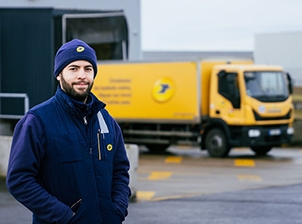 post man in front of a frenc post van