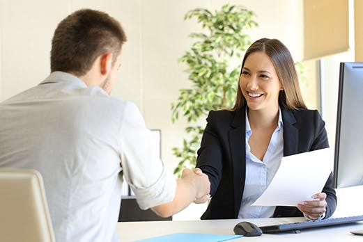 recrutement process, female manager shaking a man's hand in an office