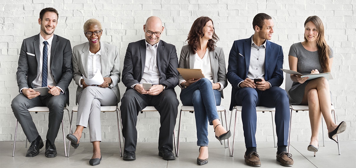 photo de plusieurs collaborateurs assis sur des chaises, qui sourient et rient