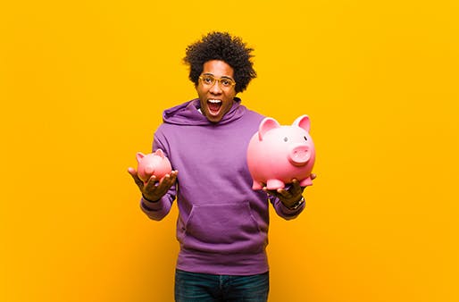 man holding two piggy banks