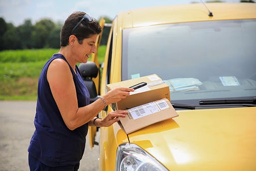a postal worker scanning parcel