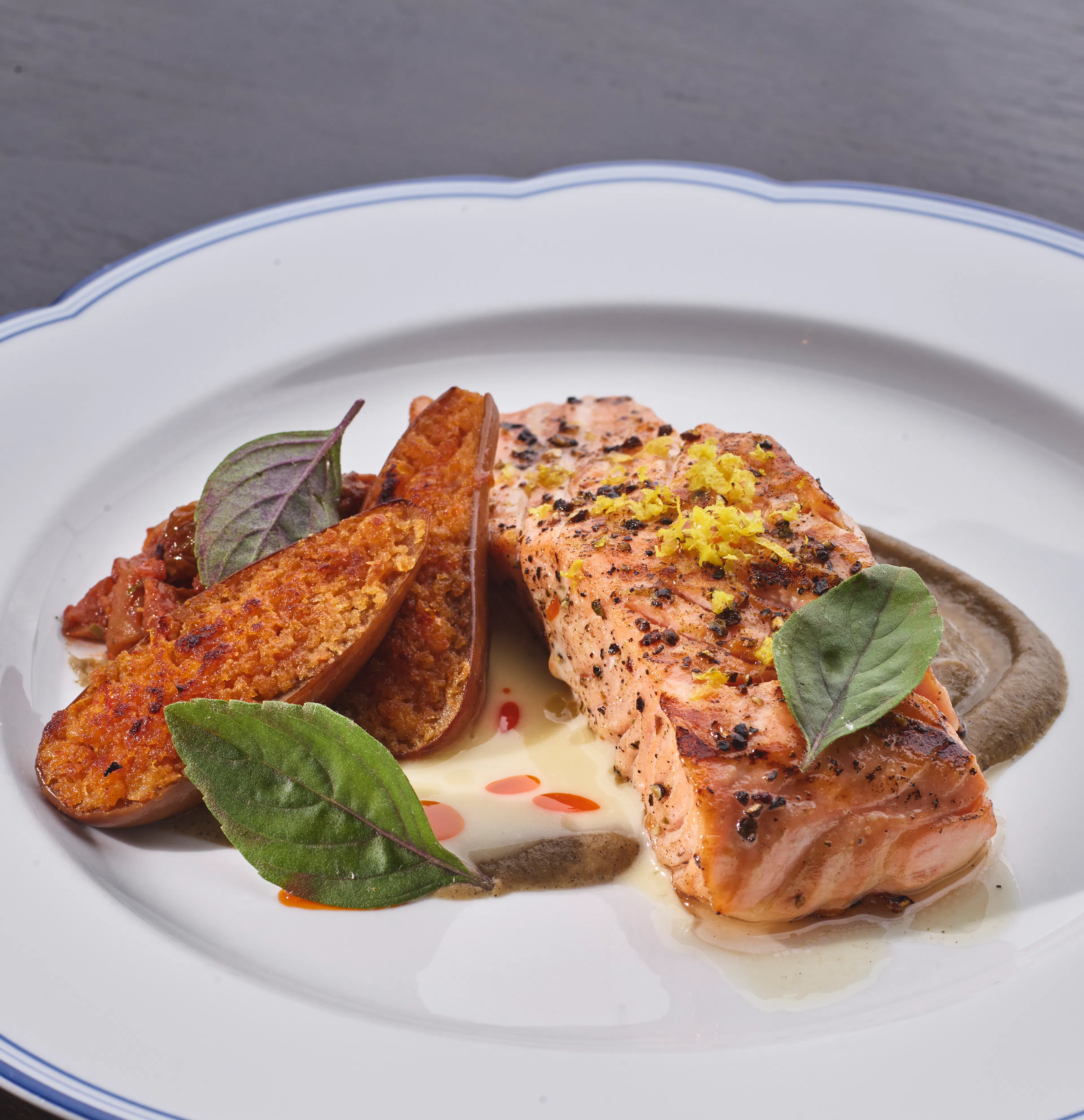 Faroe Island salmon with Fairy Tale eggplant and caponata, finished with fresh herbs and lemon zest.