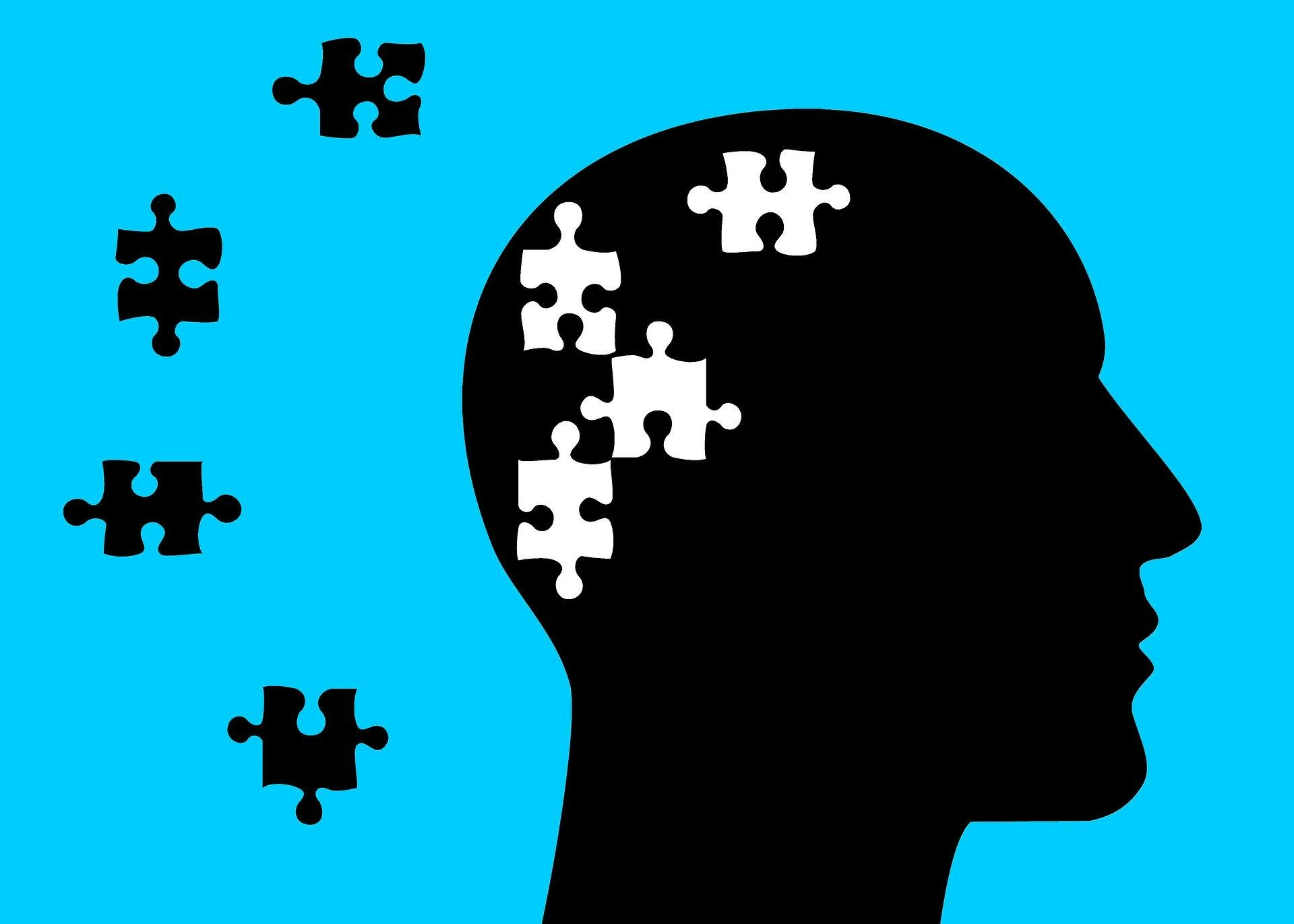 Illustration: A silhouette of a face with puzzle pieces in the brain and floating outside of the head