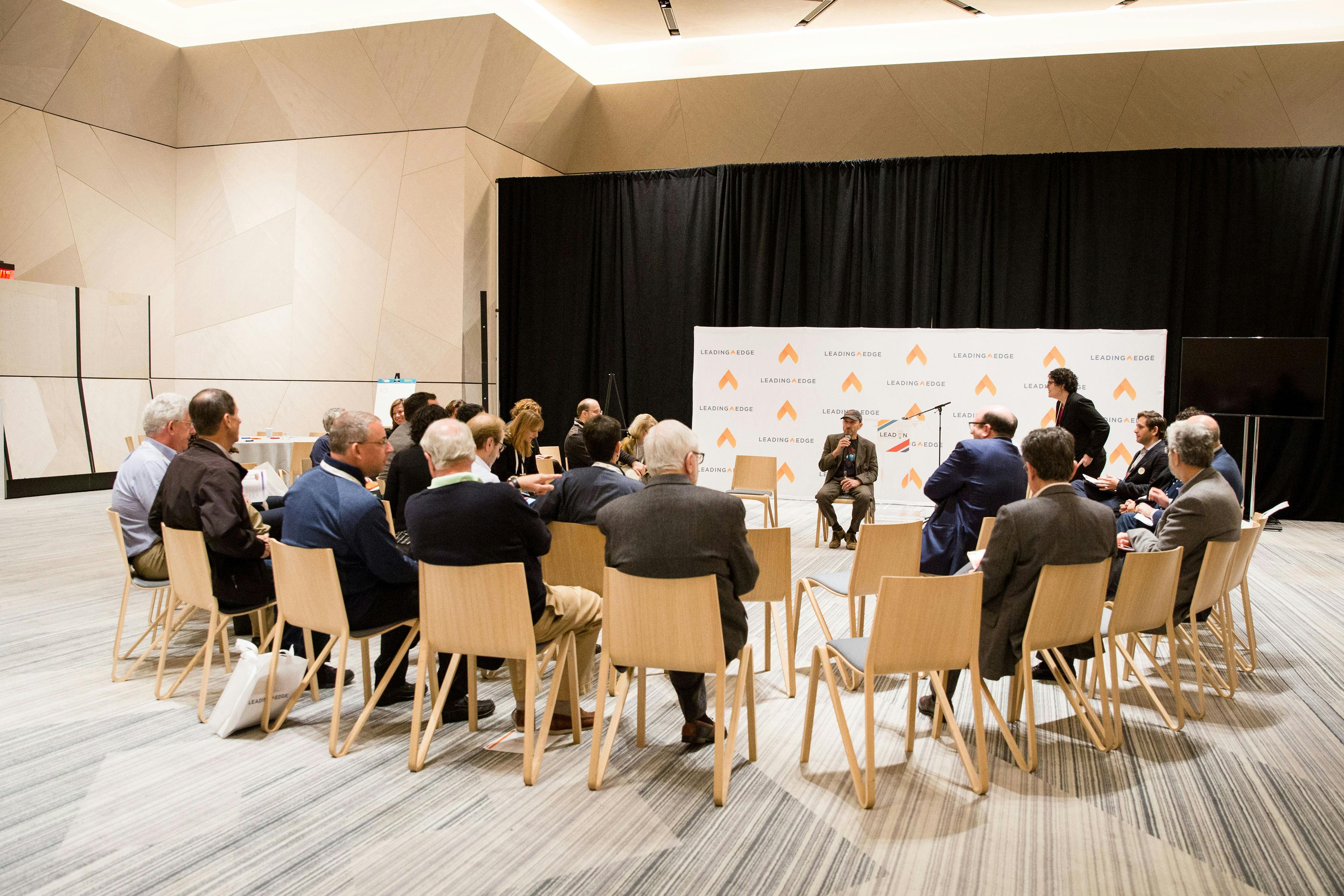 Participants listen to a speaker at a Leading Edge event.