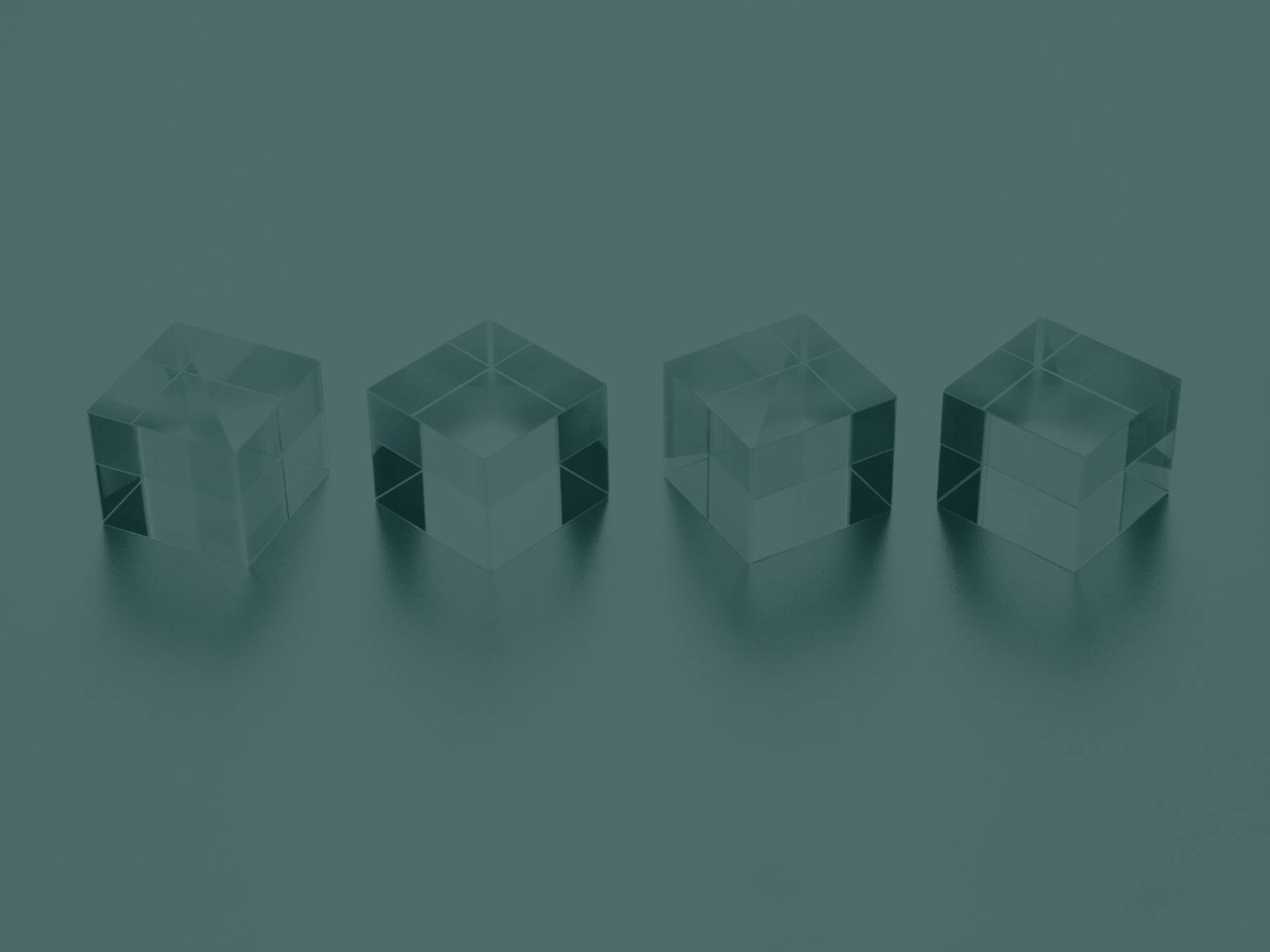 Four crystal cubes are lined up in a row.