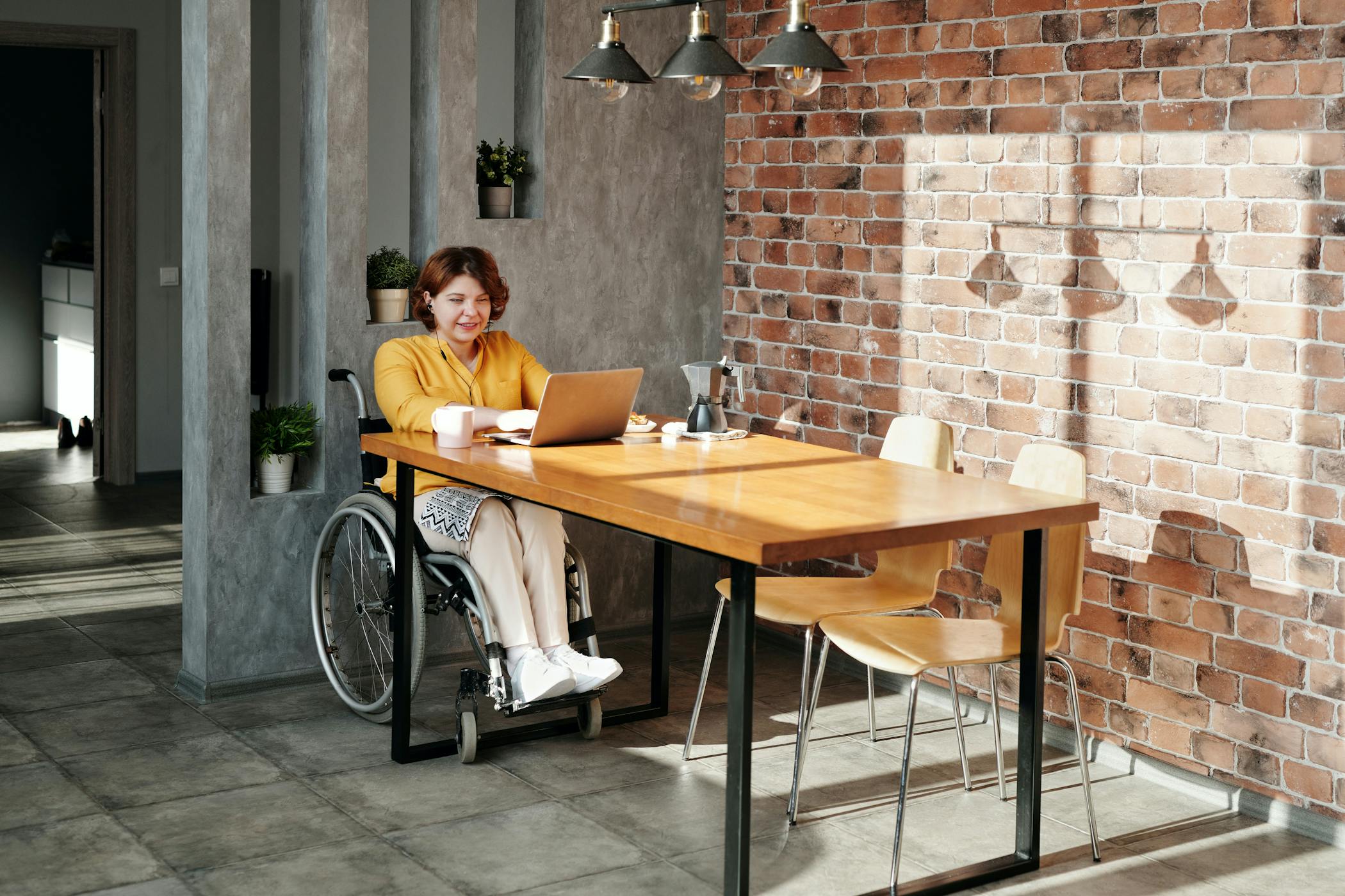Woman in a wheelchair using a laptop