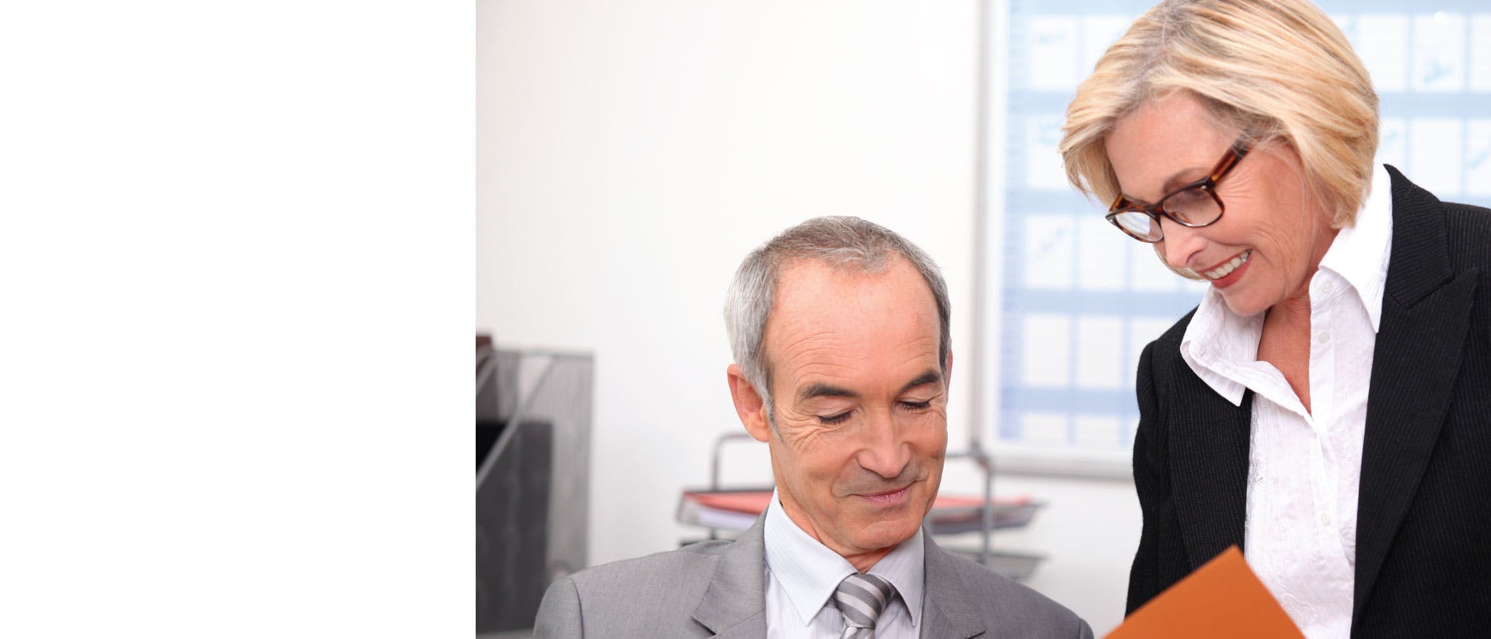 Photo of a man and woman working together in an office