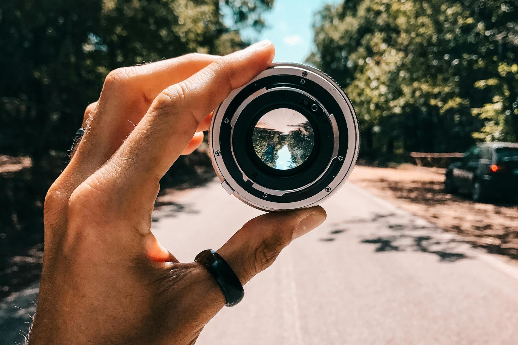 Person holding a lens