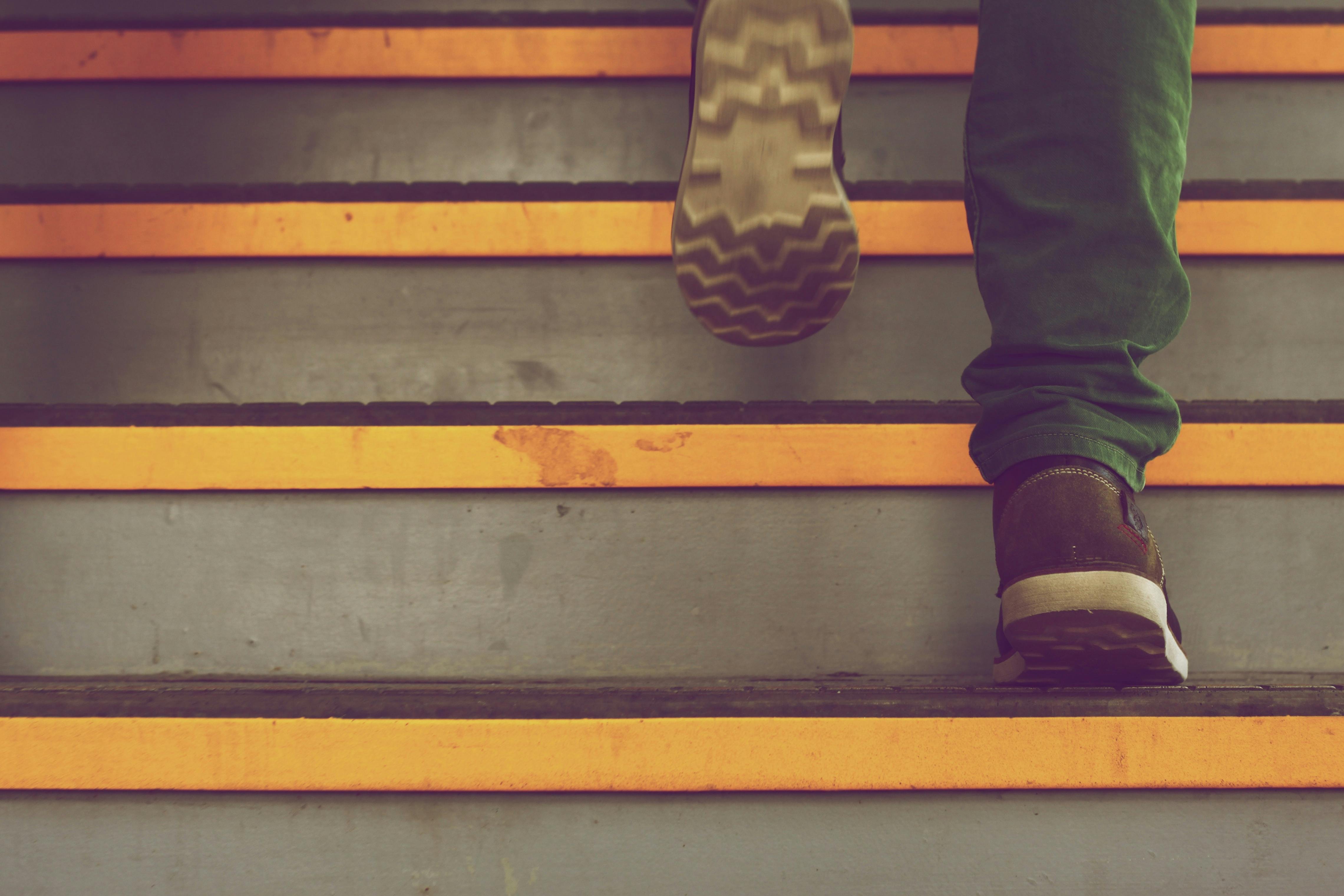 Close-up of two feet walking up the steps