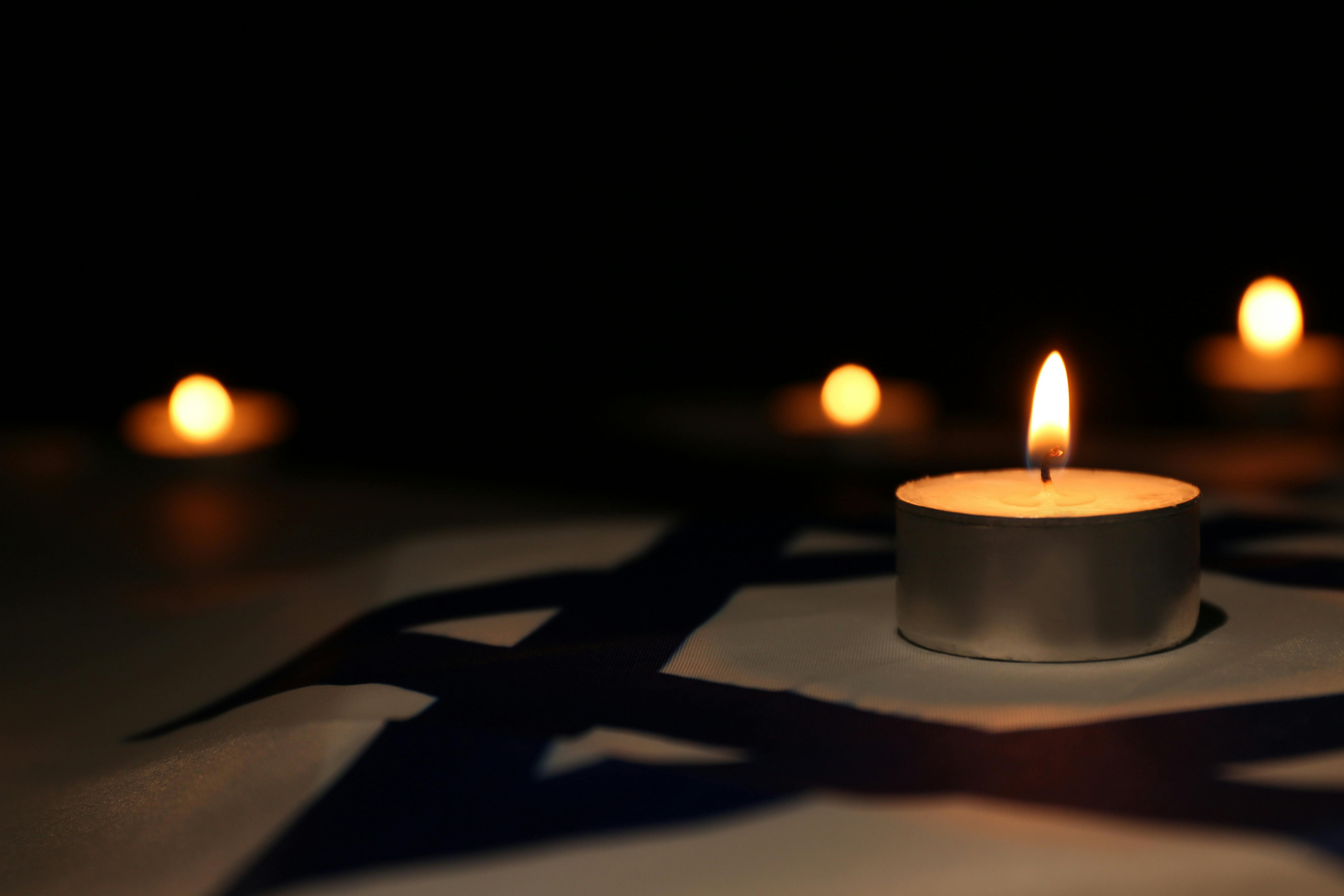 Candles are lit atop the Israeli flag.