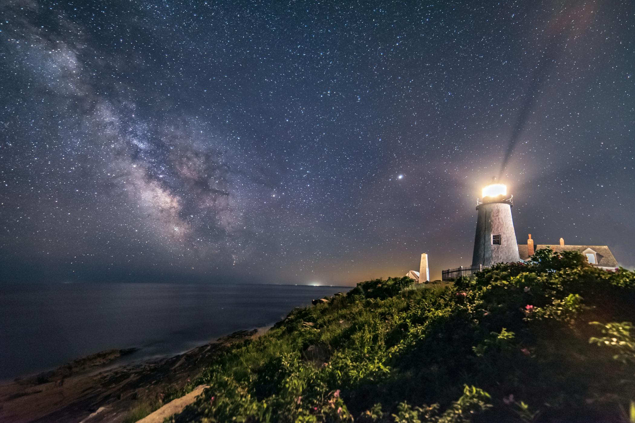 A lighthouse shining at night.