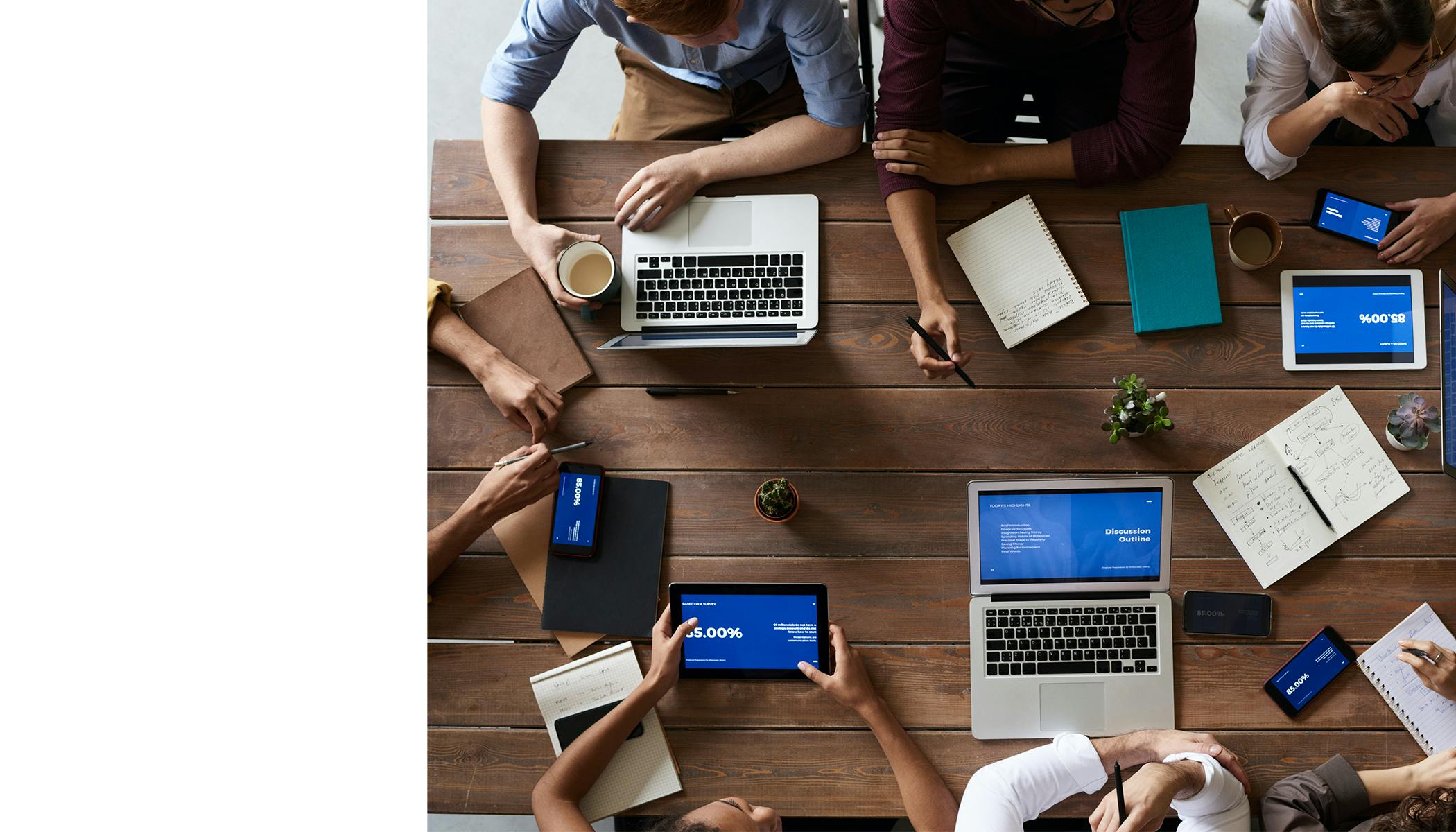 Top view photo of people sitting at wooden table