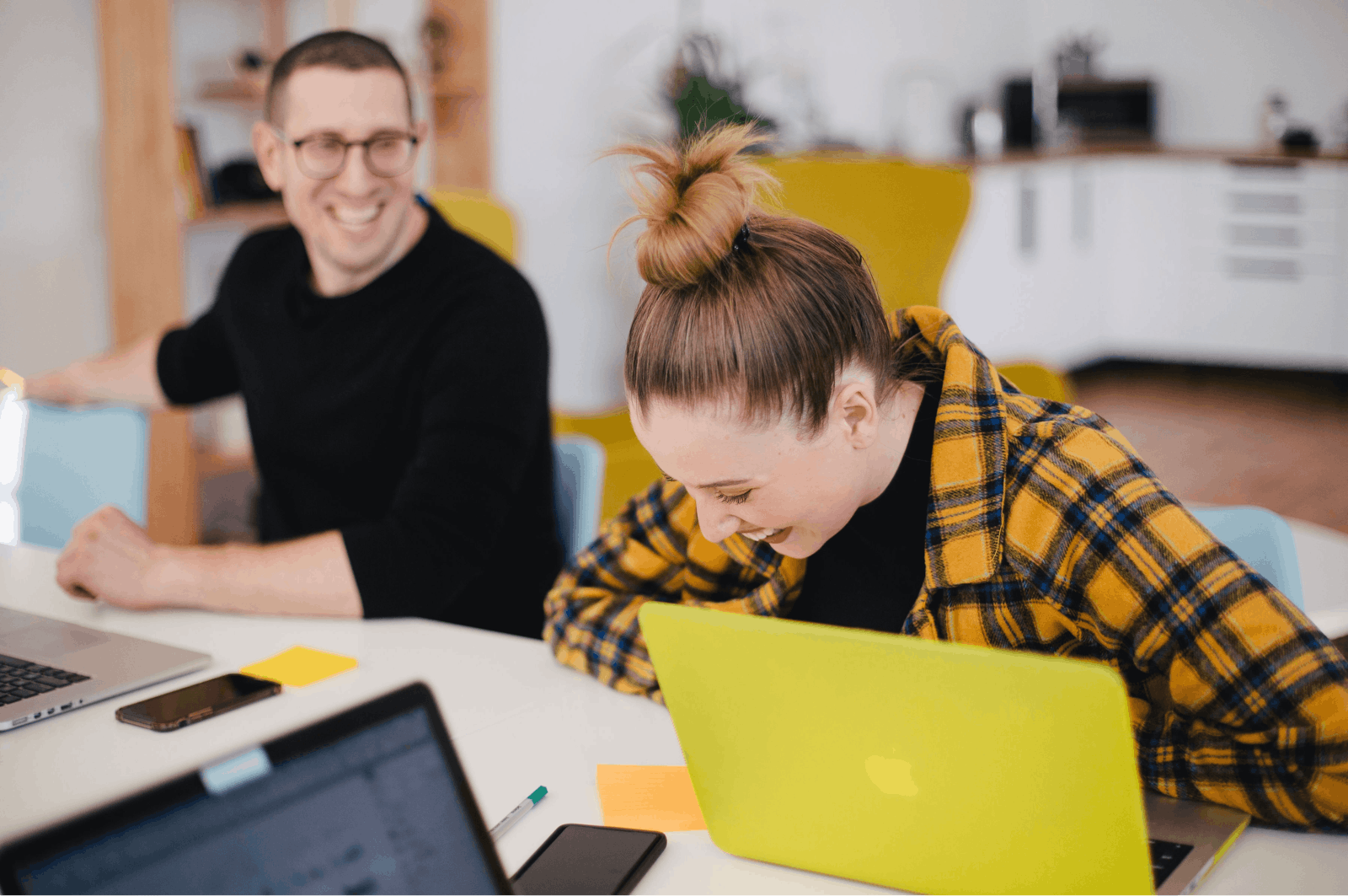 Co-workers laughing together