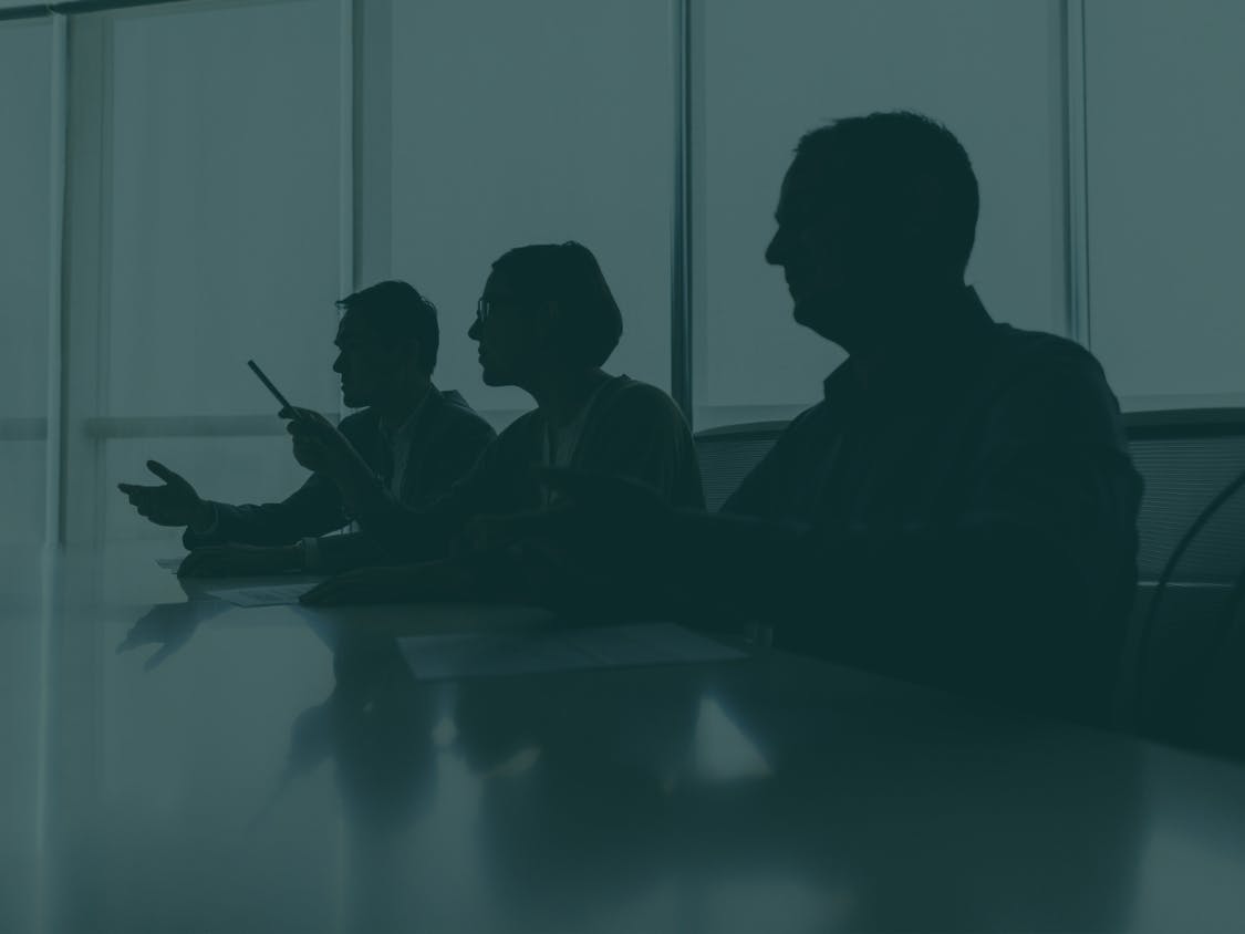Silhouettes of board members arguing.