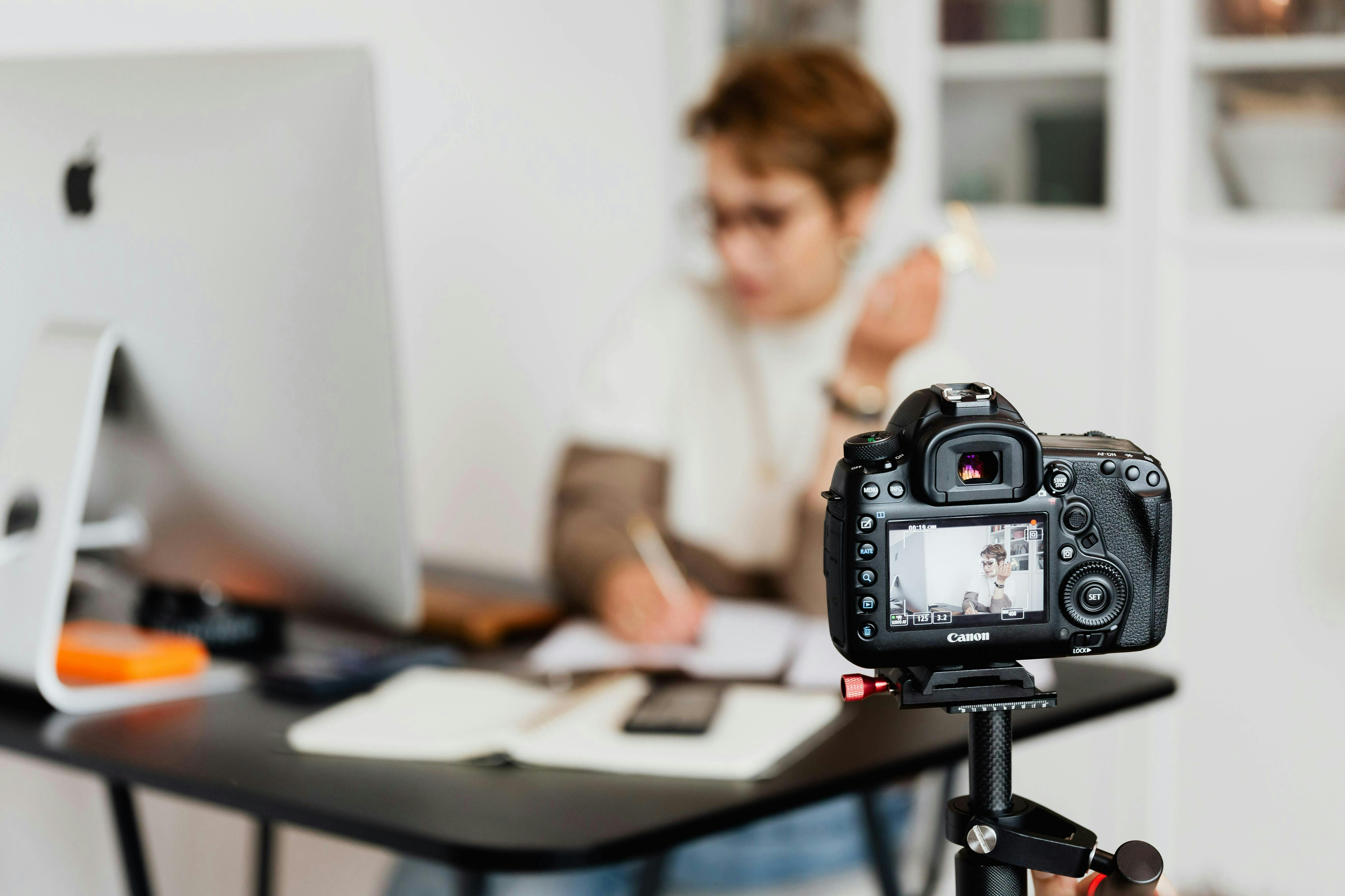 A camera captures an employee working in an office