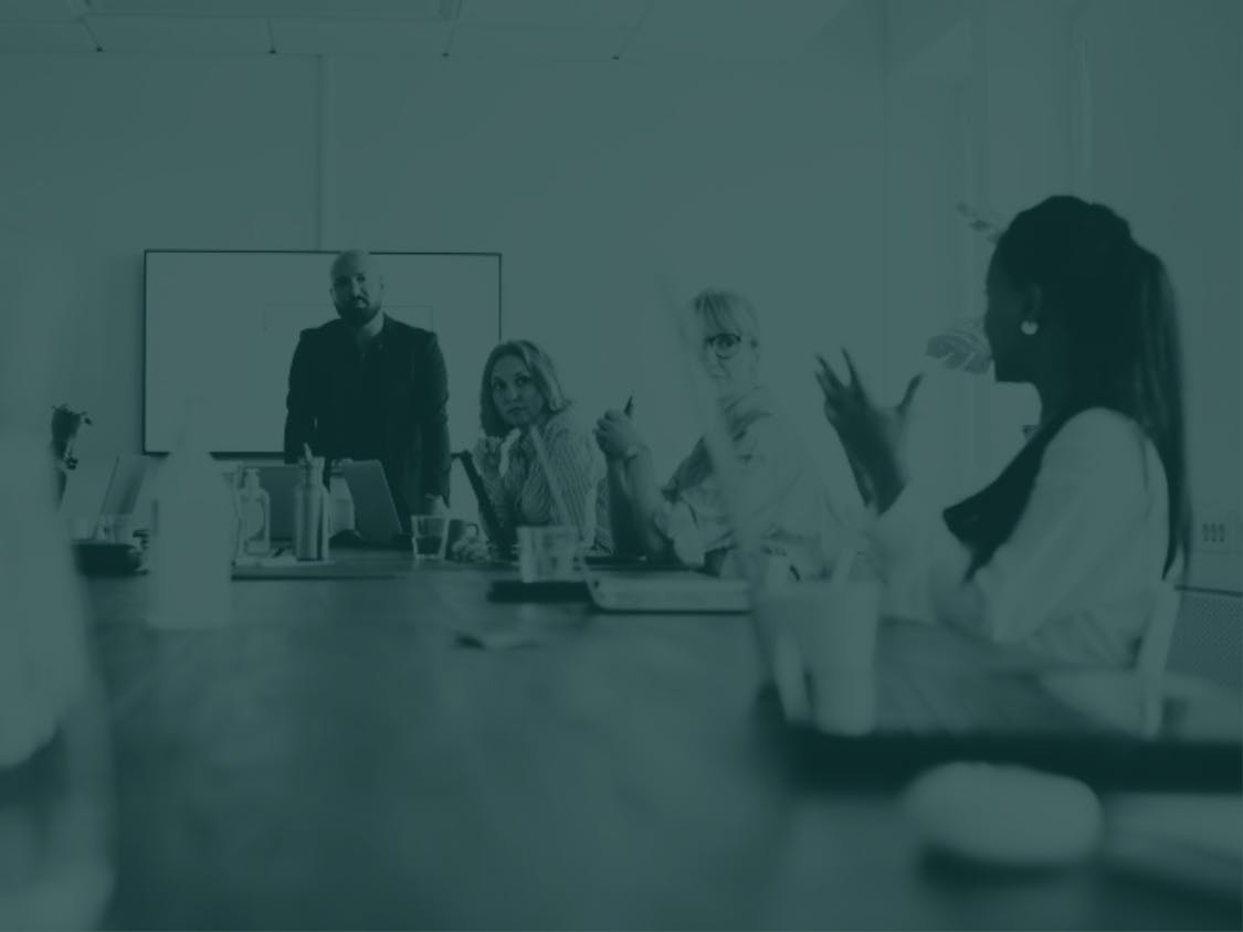 A woman talks at a meeting.