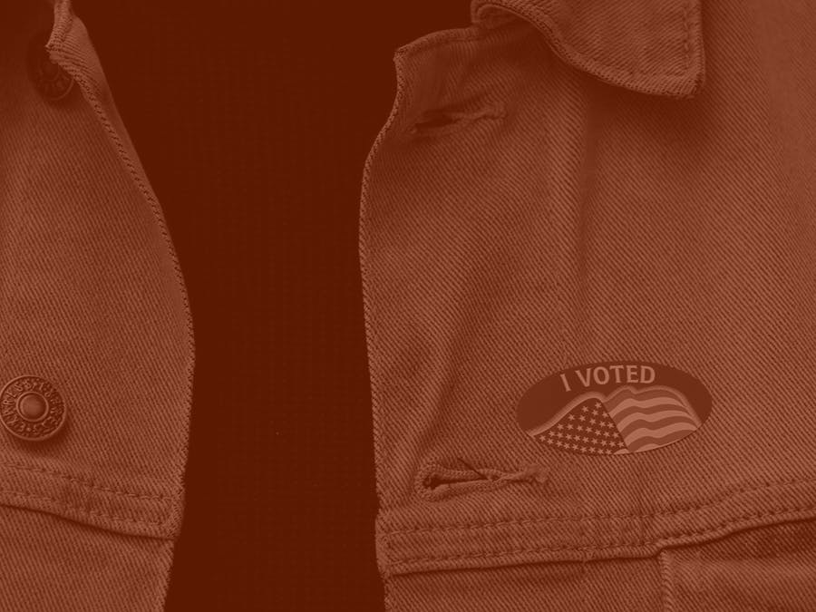 An "I voted" sticker is seen on a jacket.