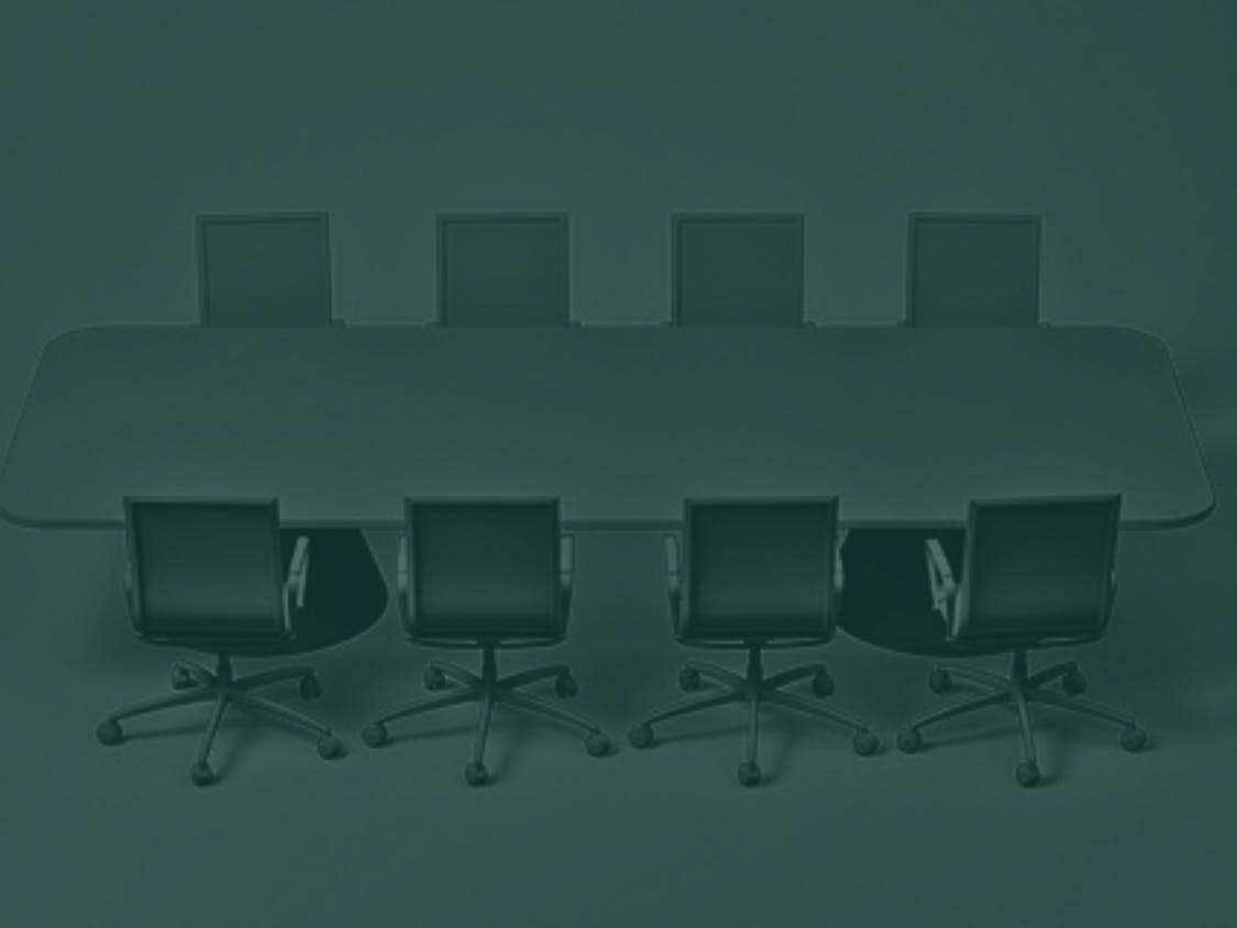 Conference table with eight office chairs.