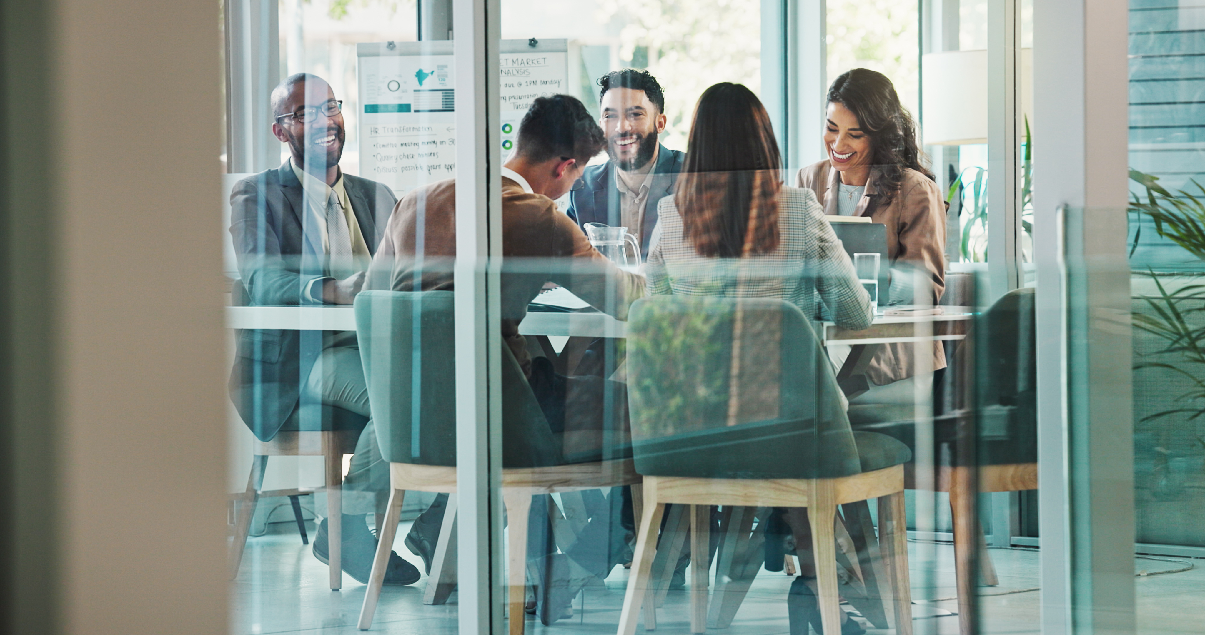 Employees laugh during a meeting.
