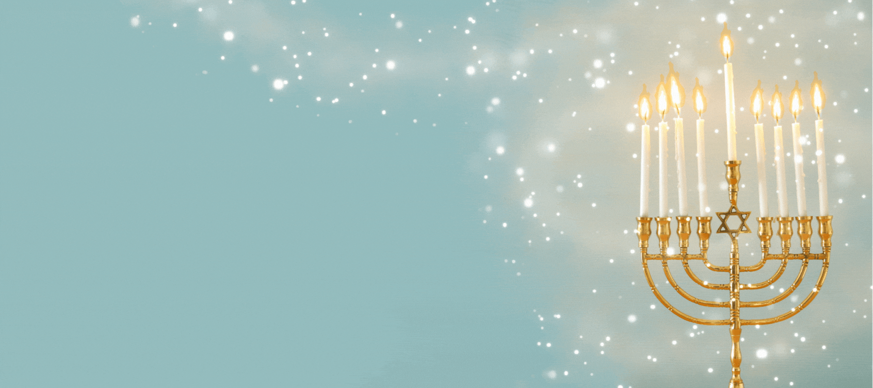 A gold menorah with eight lit candles and a central shamash.