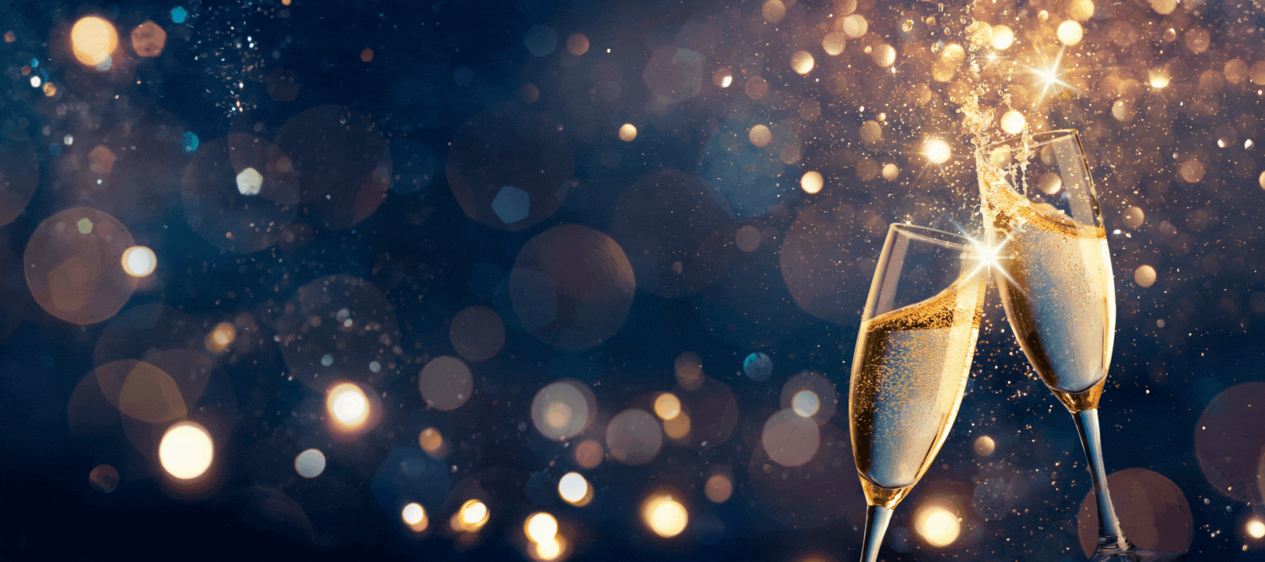 Two champagne flutes clink midair