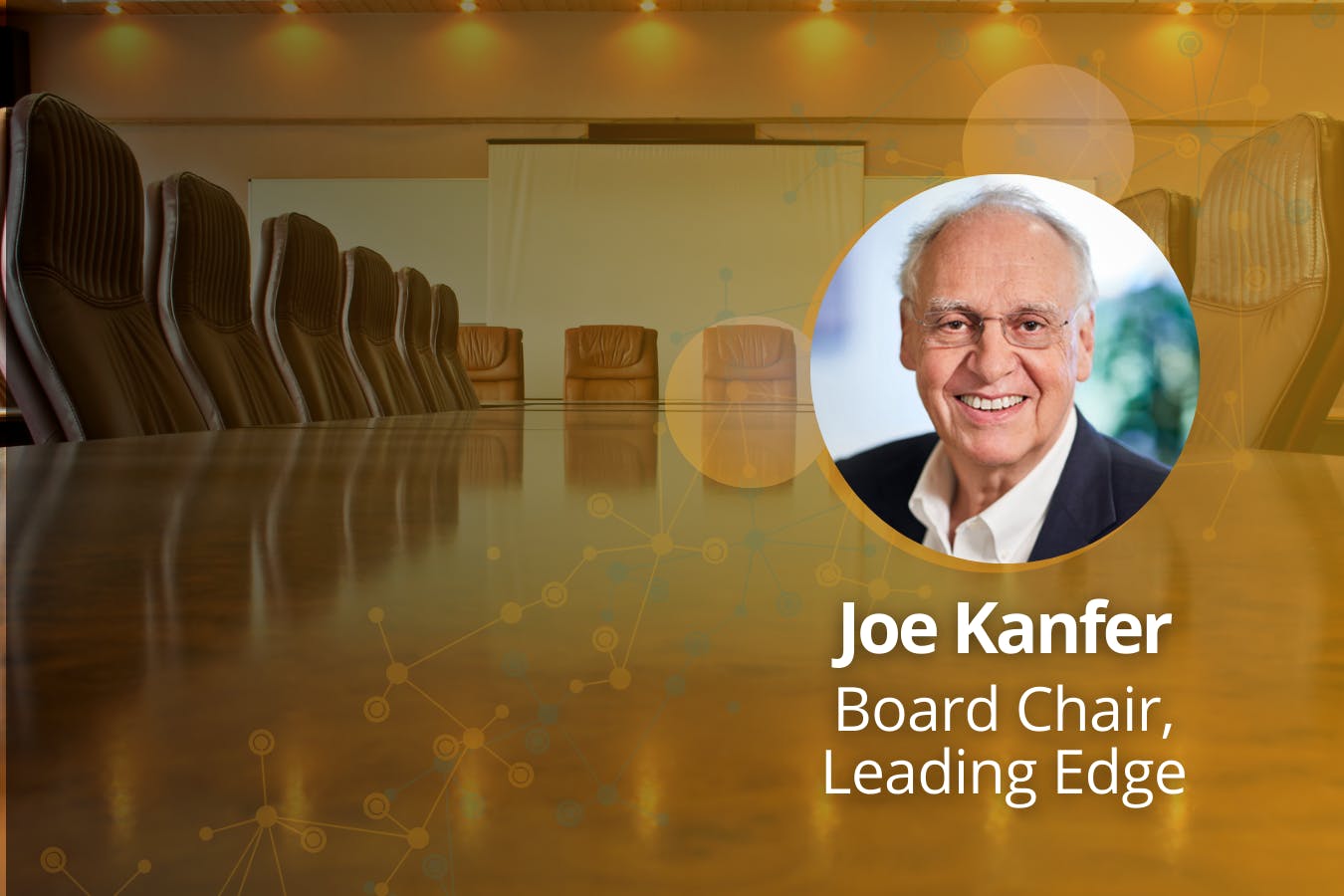 (R-L) Image of Joe Kanfer, Board Chair, Leading Edge, against background of brightly lit boardroom.