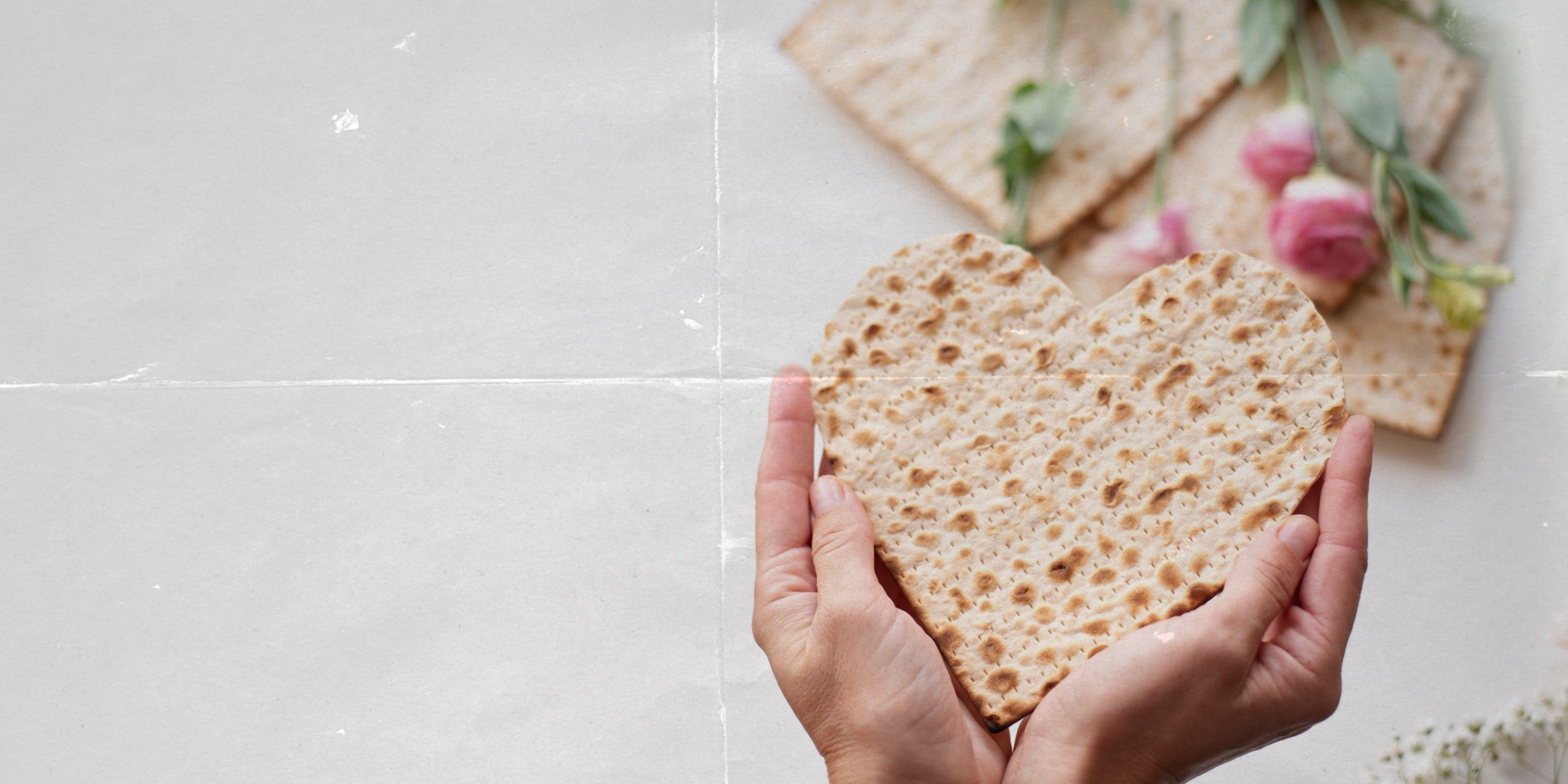 Hands holding heart-shaped matzo