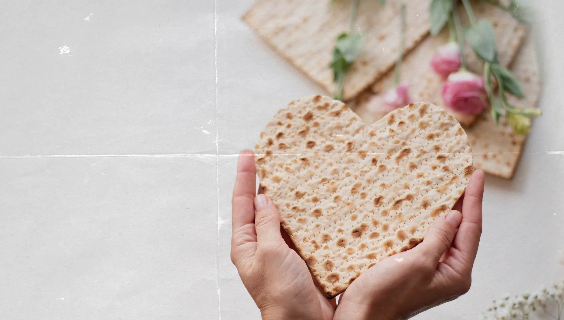 Hands holding heart-shaped matzo