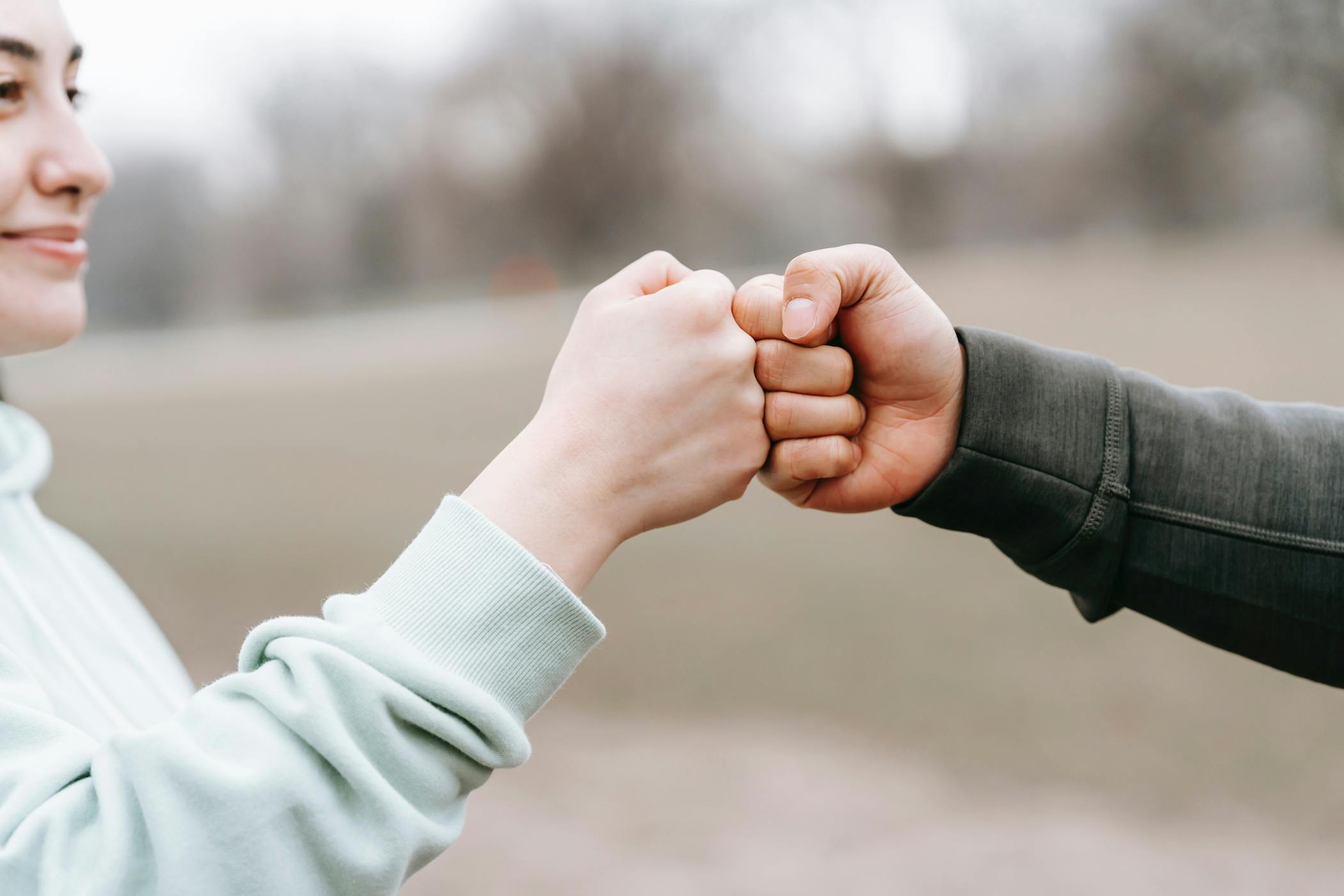 Two people bumping fists.