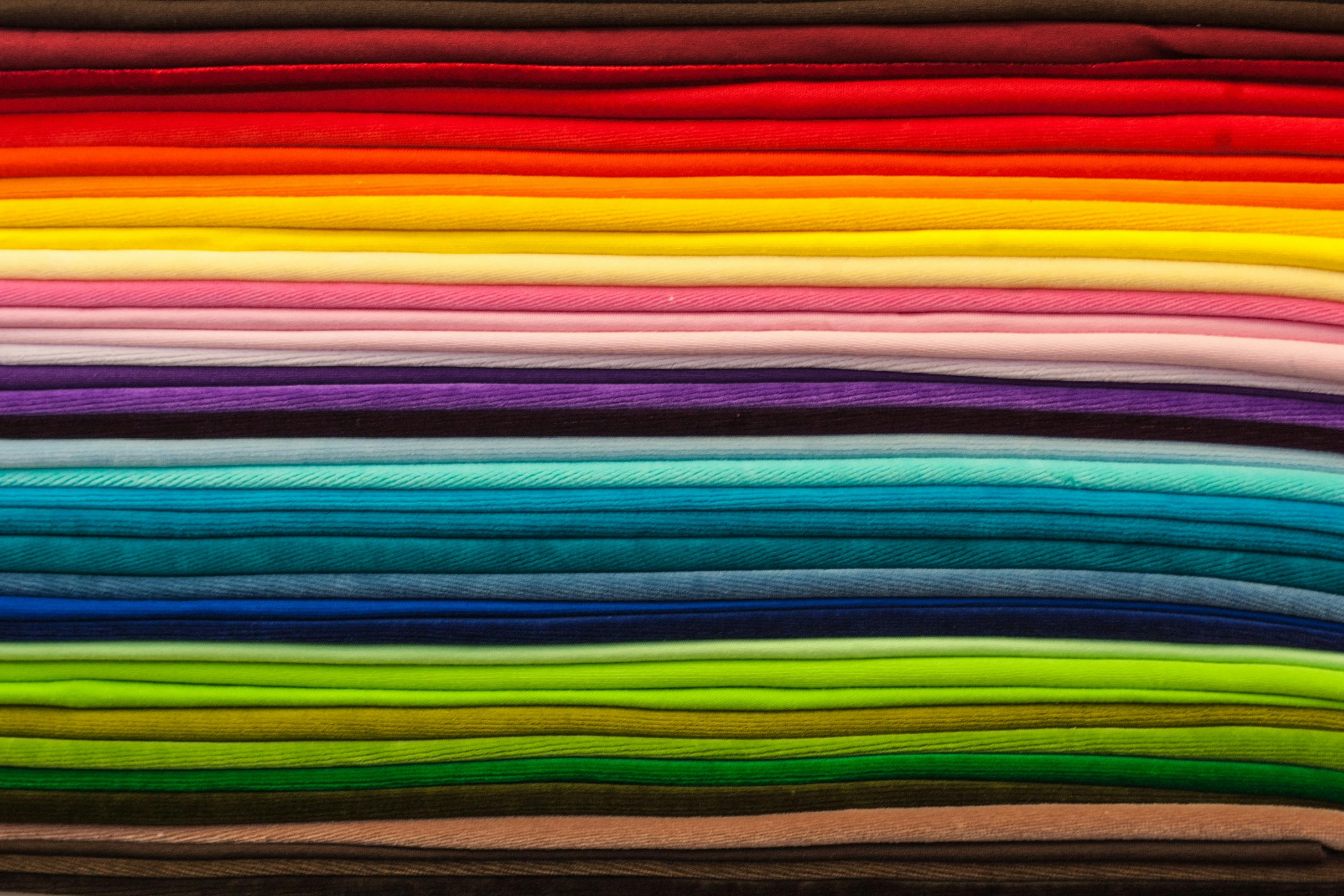 Textile art, stack of fabric in a rainbow of colors