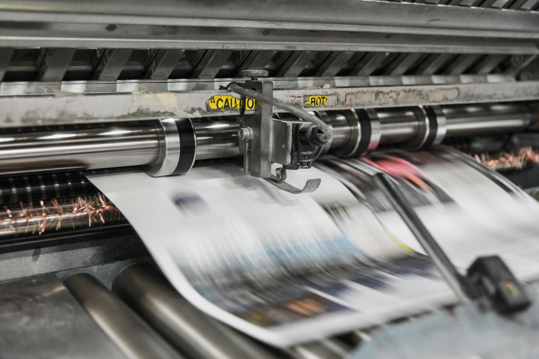 Newspaper being printed with a printing press