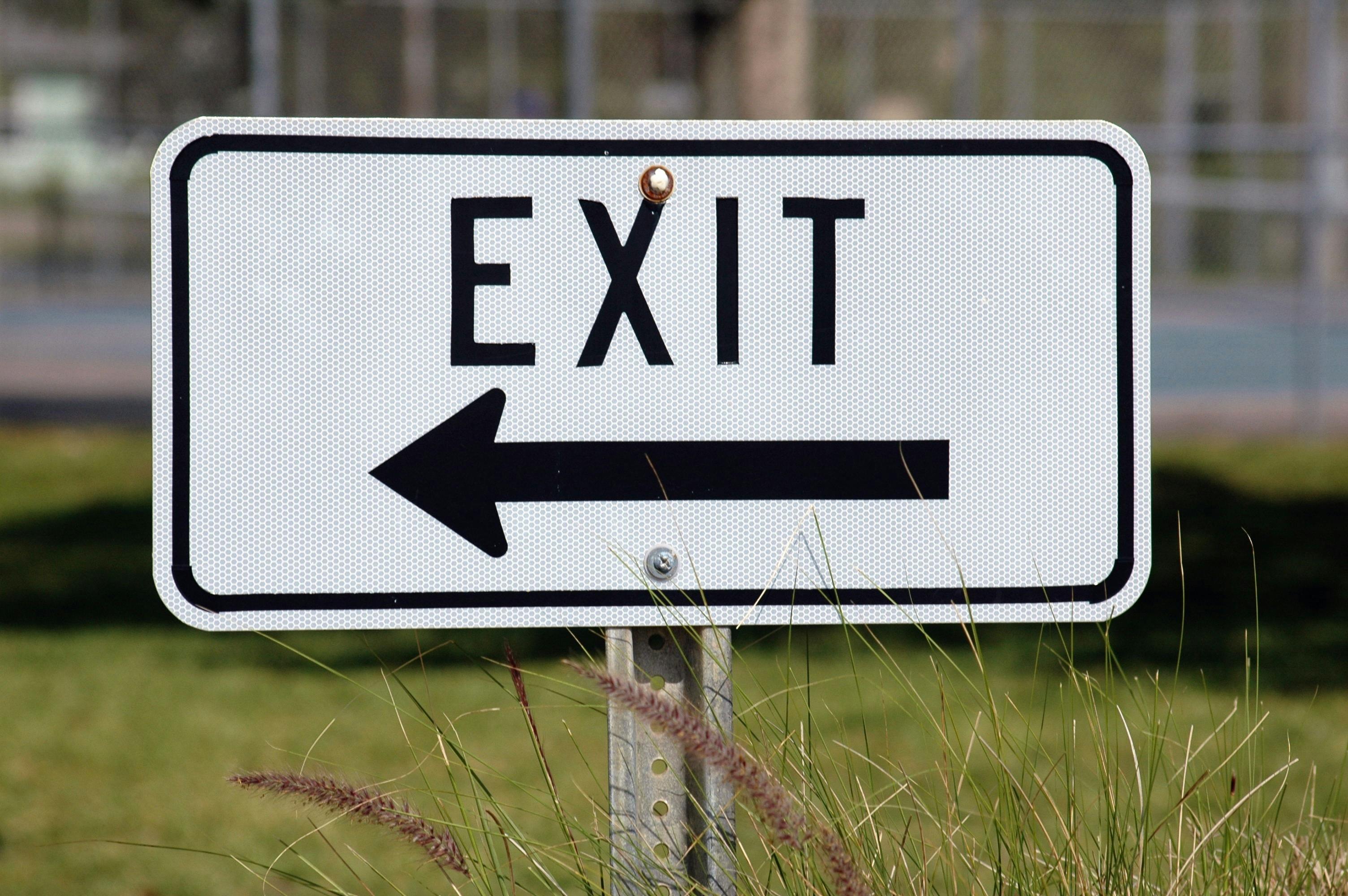 Exit sign with arrow pointing left.