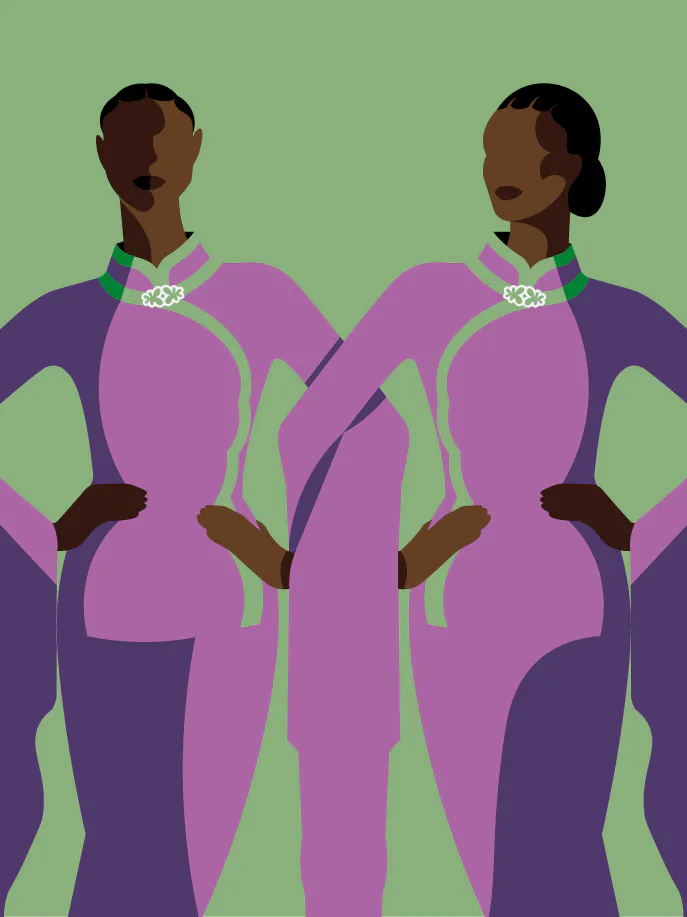 two women in purple dresses standing next to each other.
