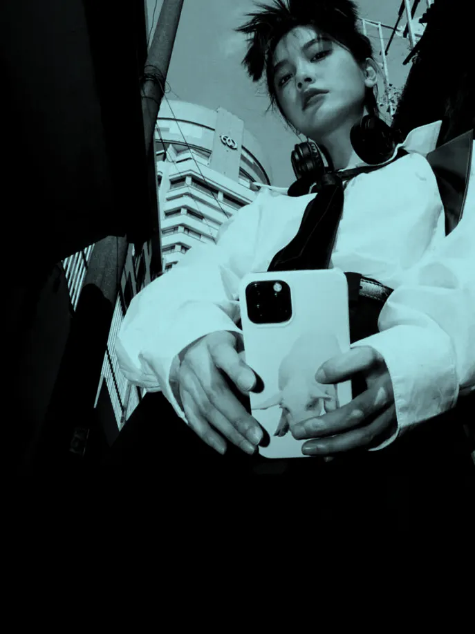 a black and white photo of a woman holding a cell phone.