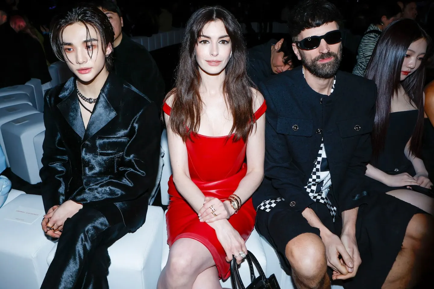 Anne Hathaway and Hyunjin sit front row of the Versace AW24 show.