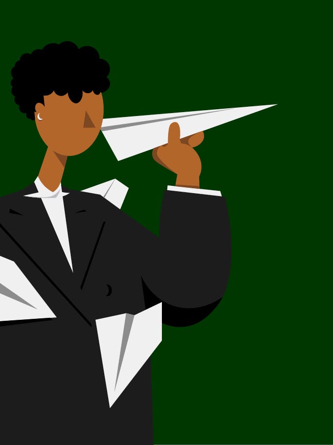 a businessman holding a paper airplane.