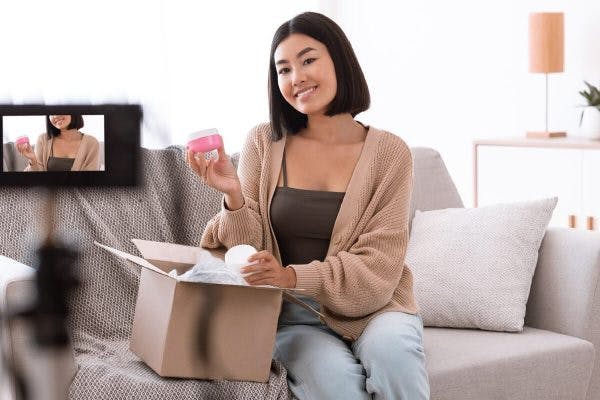 Influencer with a product shooting a video.