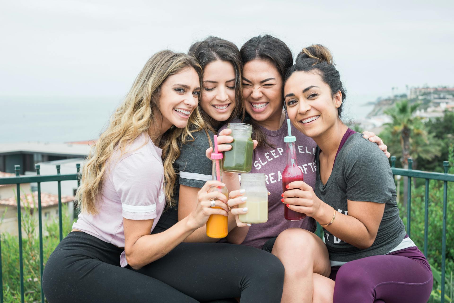 A group of girls drinking smoothies.