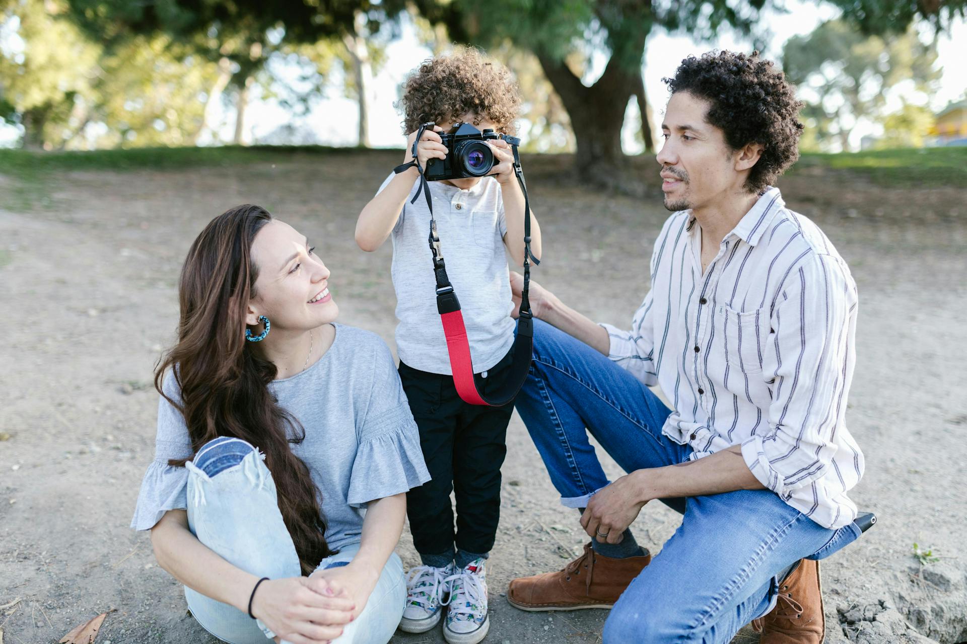 A child and his parents with a camera.