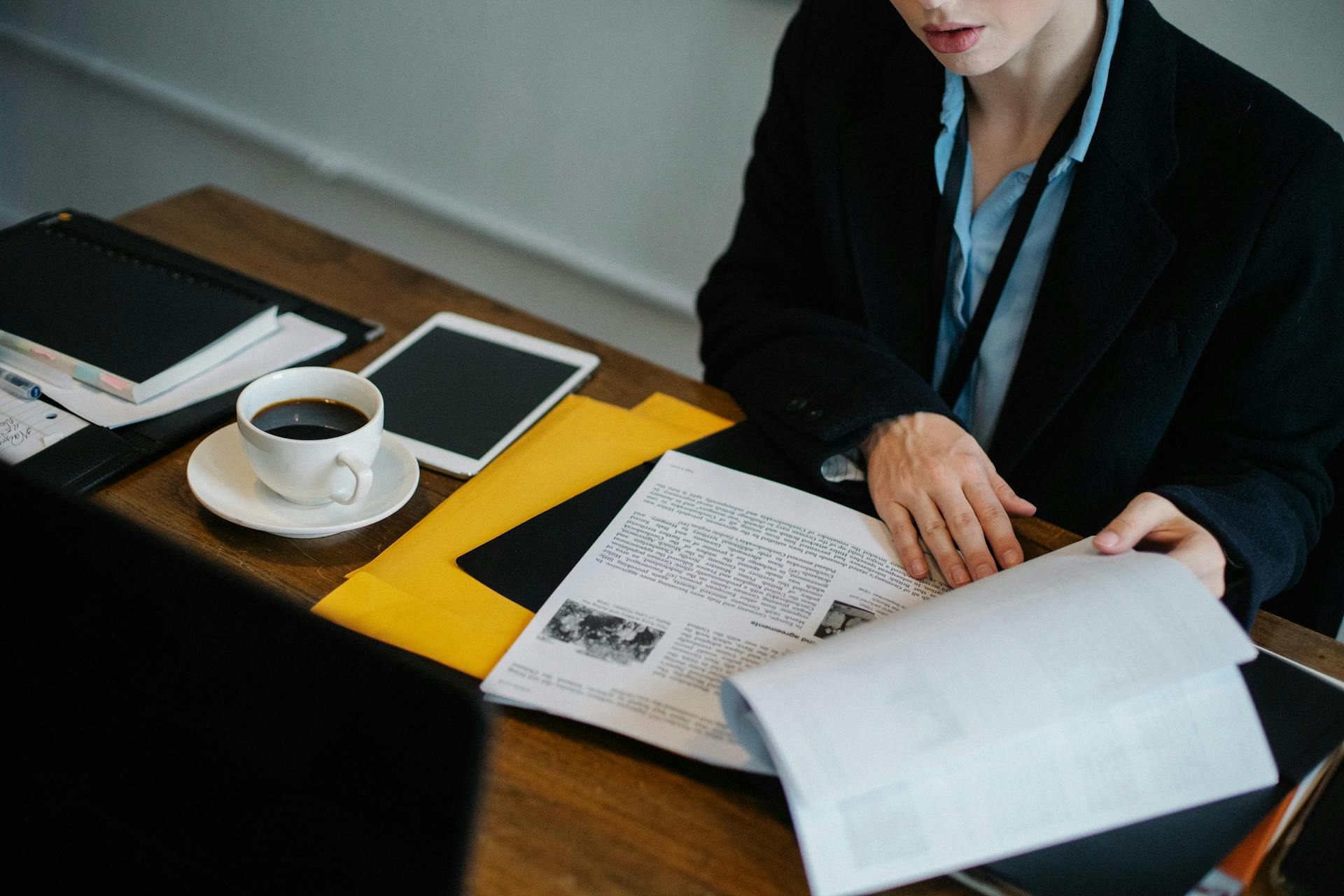 A woman looking over pages.