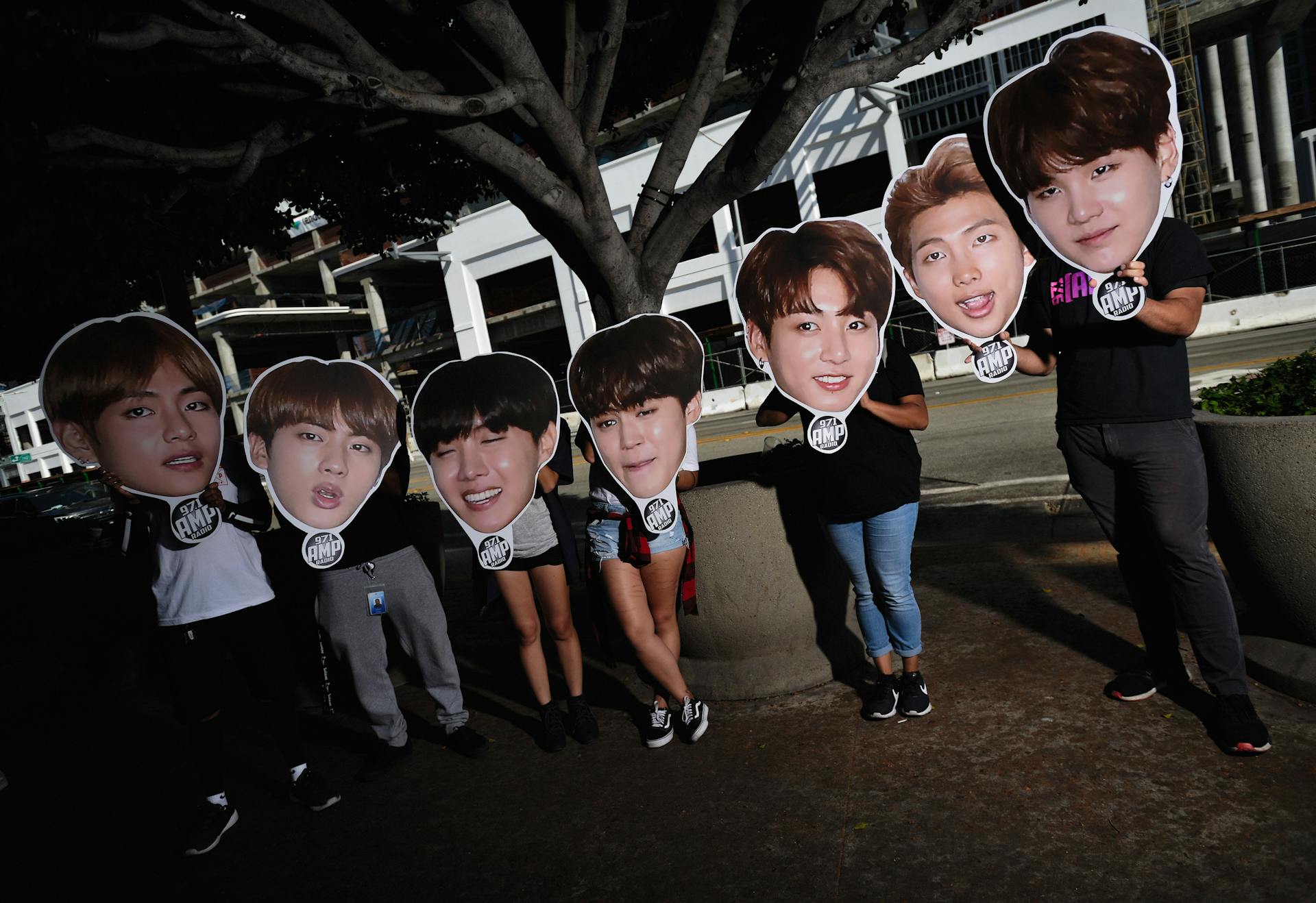 K-pop fans supporting their idols with signs.