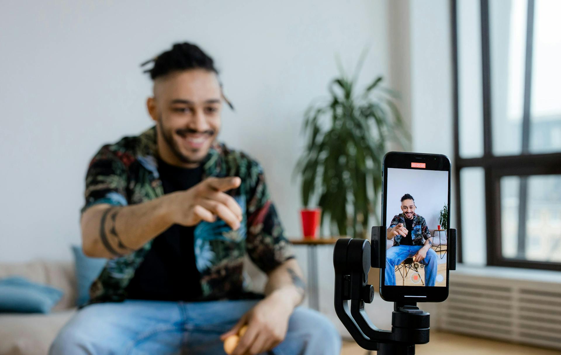 A man vlogging on his phone.