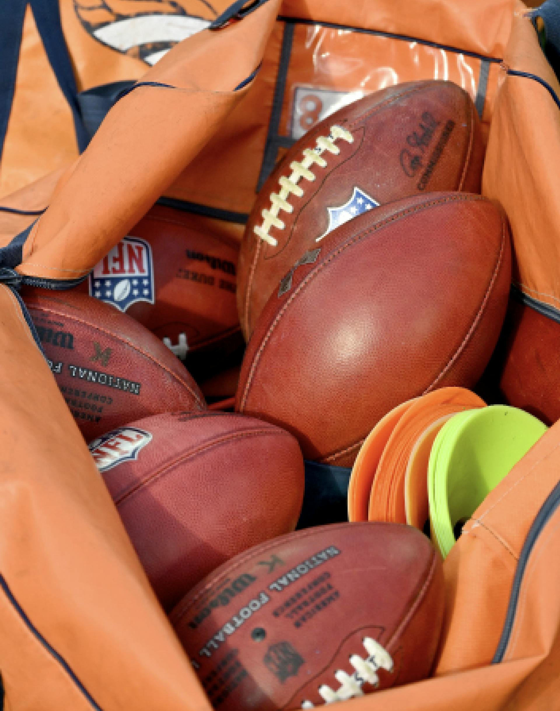 A pile of American footballs. 