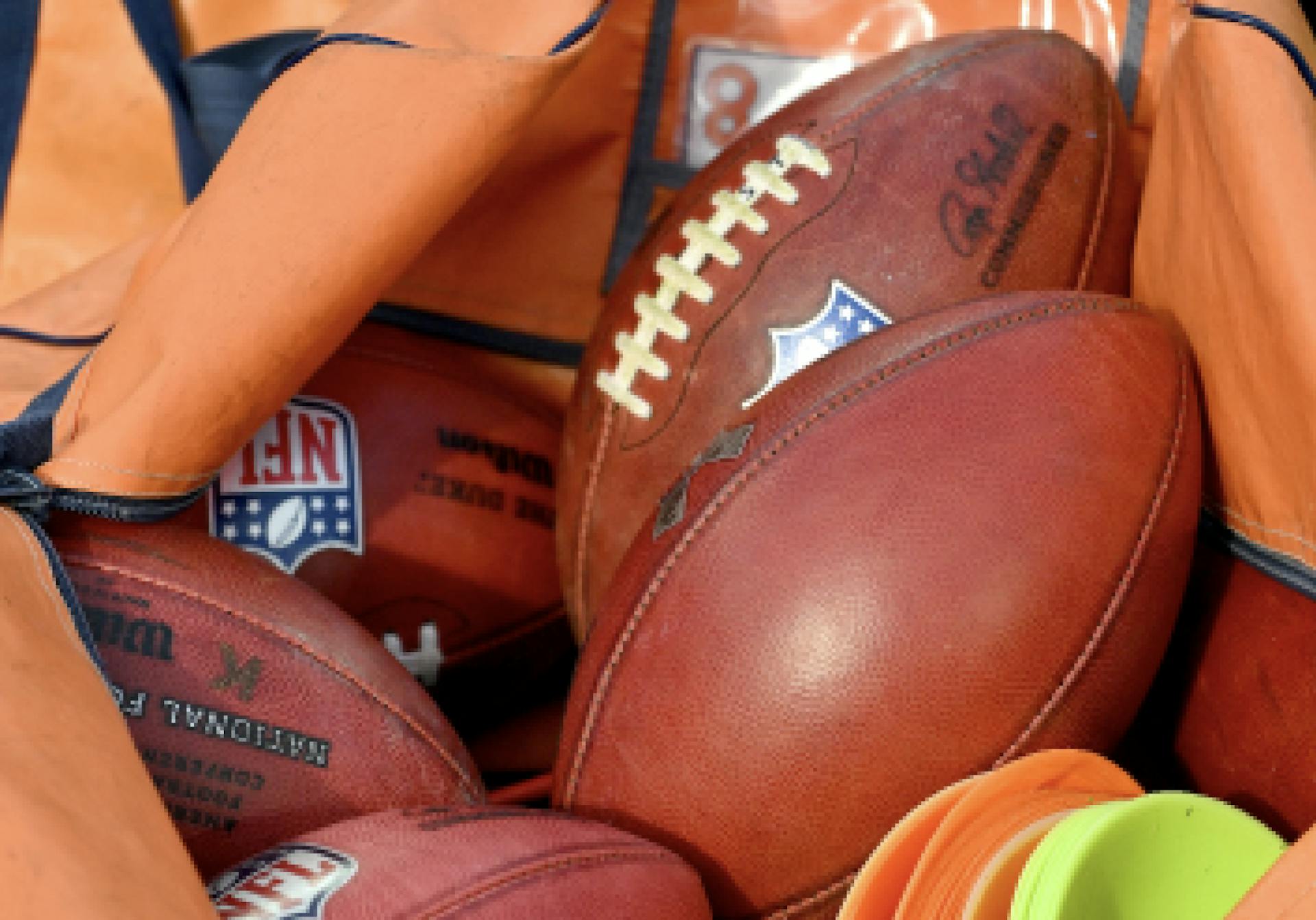 A pile of American footballs.