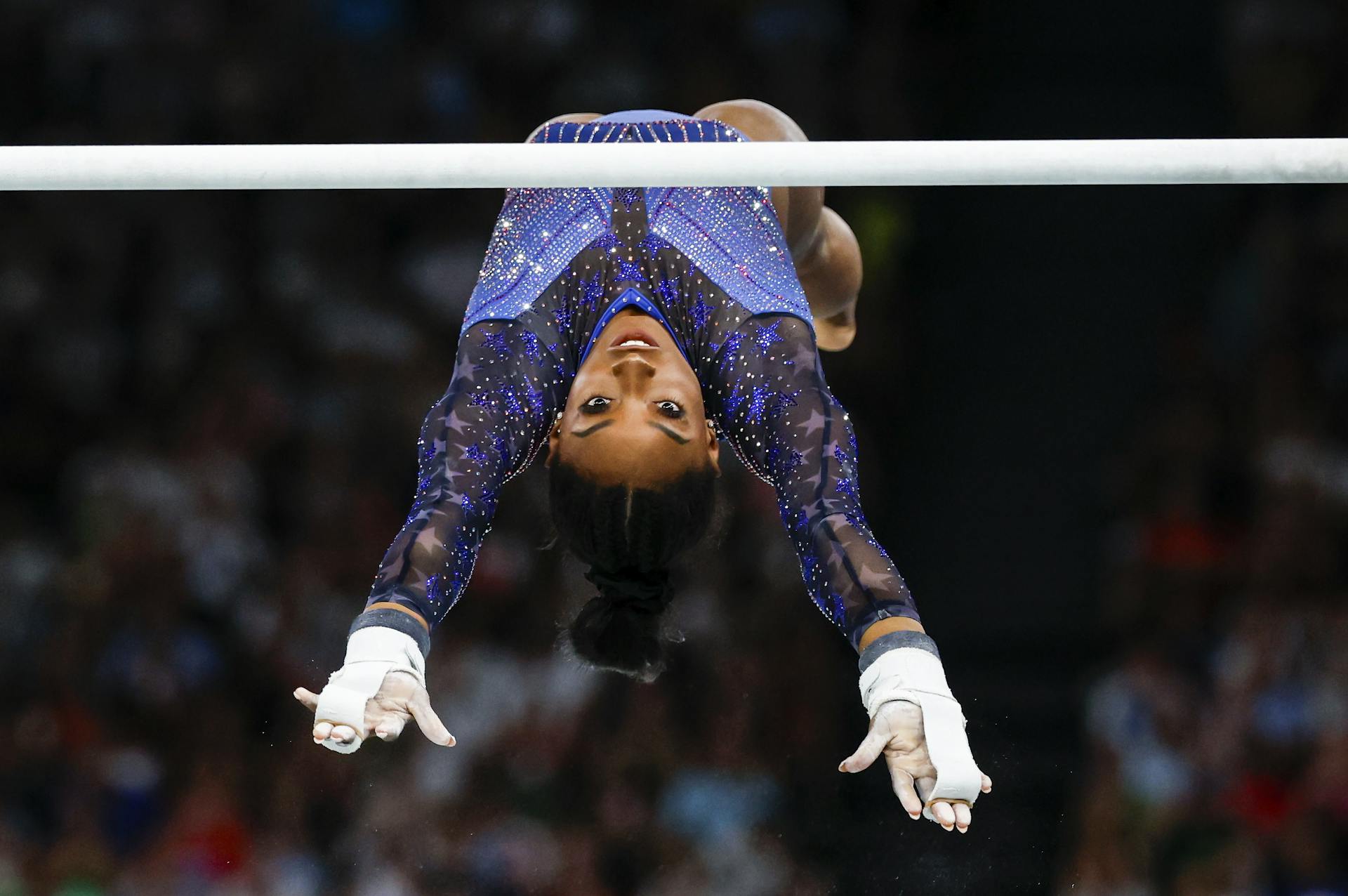 Simone Biles on the horizontal bars.