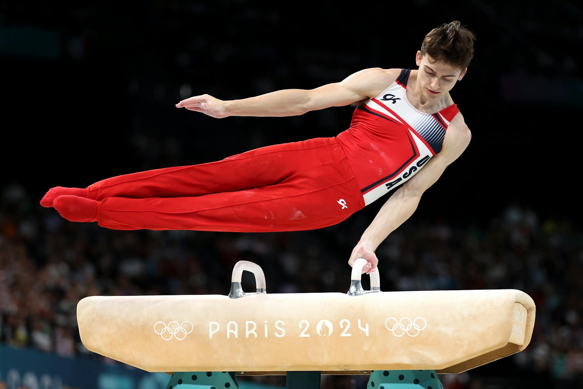 An athlete performing at the pummel horse event